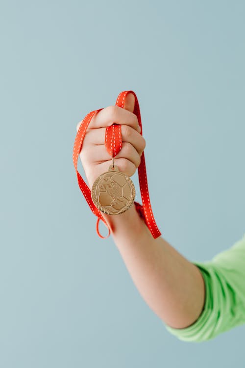 Free Person Holding a Medal Stock Photo