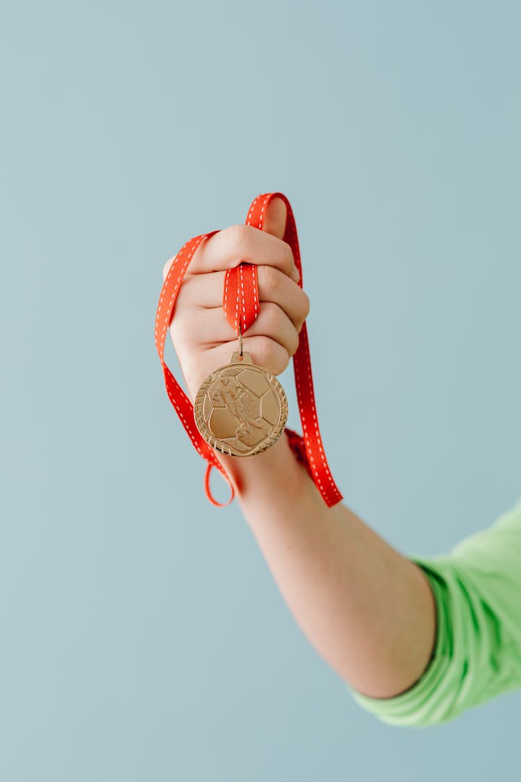 Person Holding A Medal