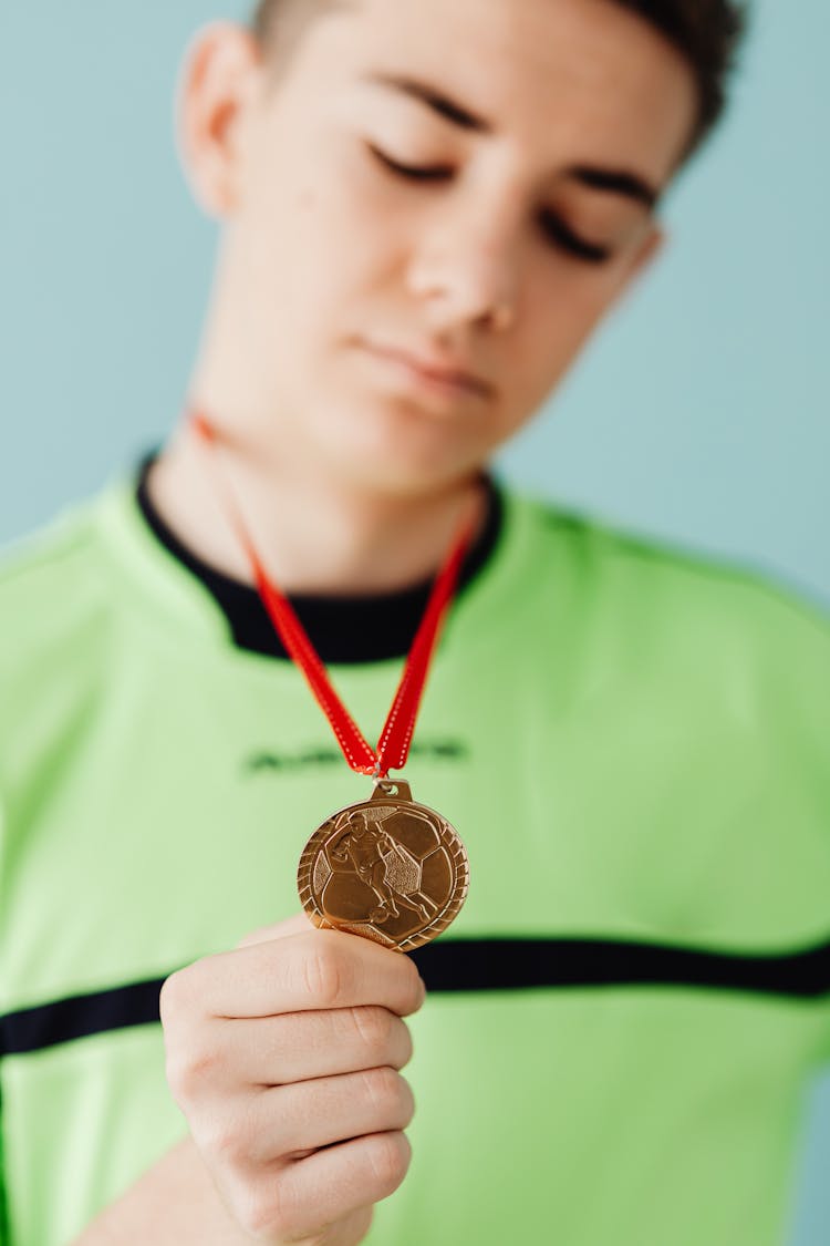 Guy Showing Gold Medal