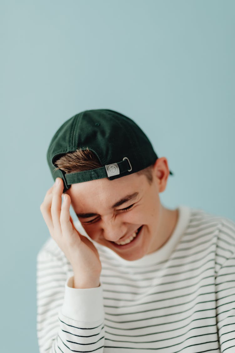 A Man Wearing Cap Backwards Laughing