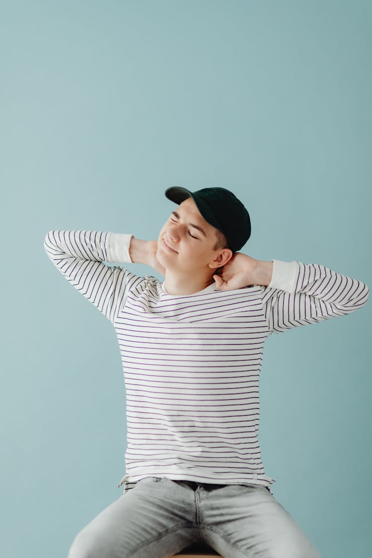 Young Man Sitting On Chair Stretching