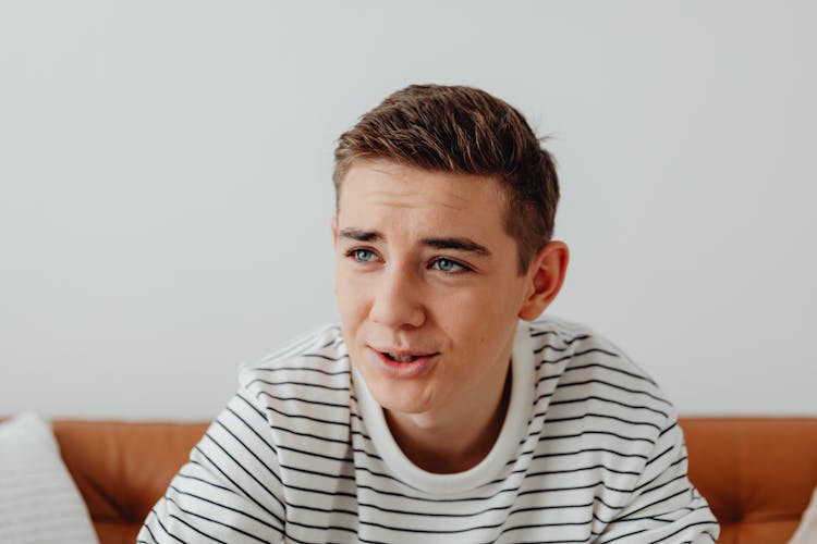 Young Man Sitting On Couch Talking