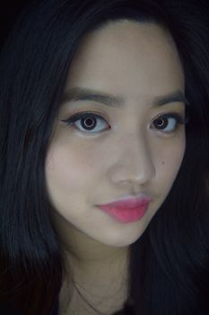 Captivating close-up portrait of a woman with striking features and elegant makeup. Perfect for beauty and fashion themes.