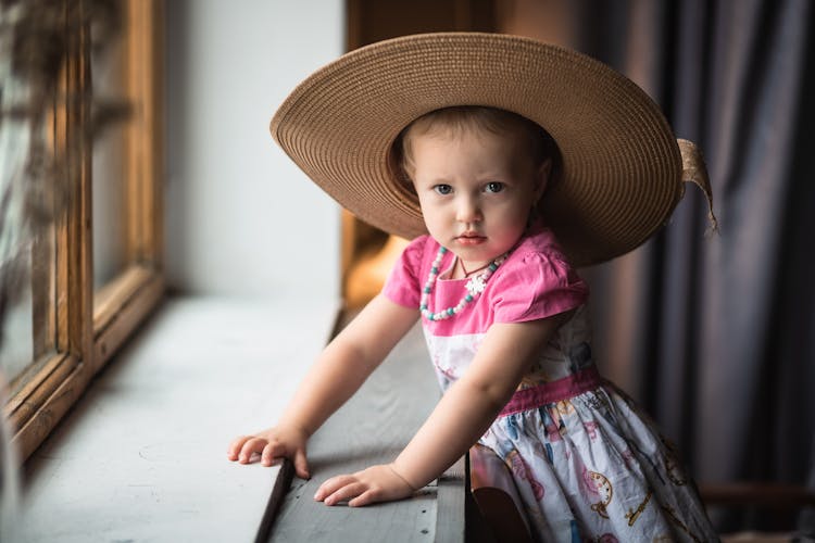 Baby Girl In A Big Round Hat 