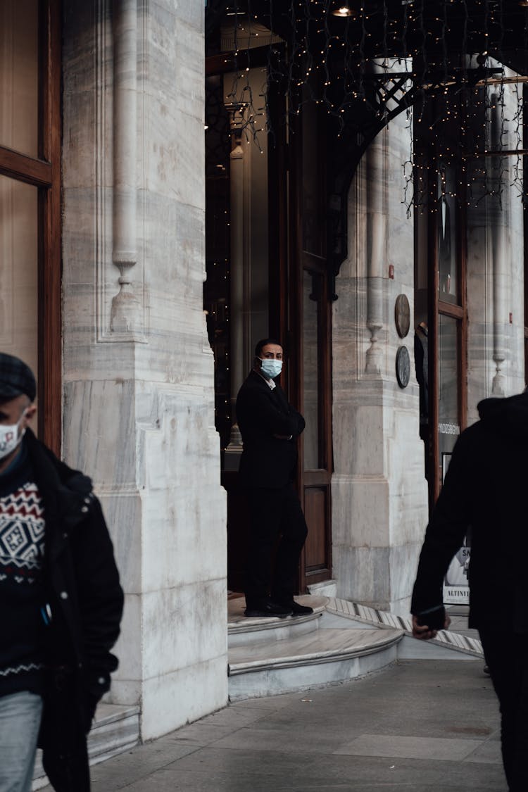 Man Standing Near Entrance Of Old Building