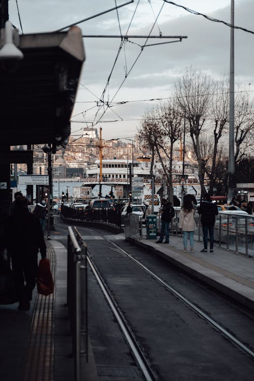 People waiting transport on platform in city