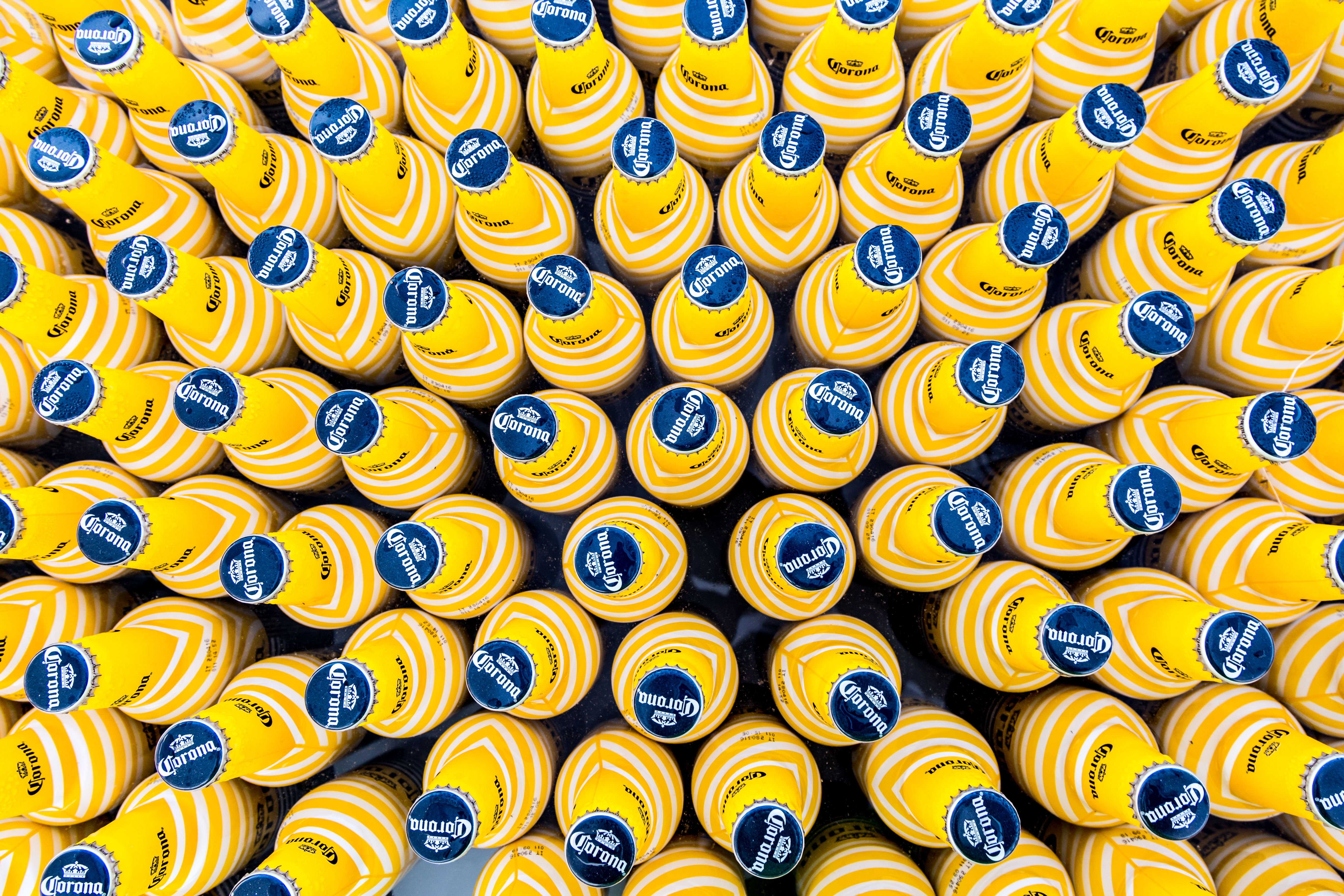 A striking top-down view of vibrant yellow beverage bottles arranged in a geometric pattern, offering visual symmetry.