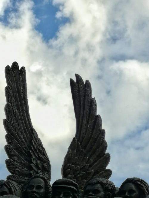 Angel Wings on a Sculpture under a Cloudy Sky