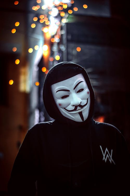 A Person Wearing a Mask and a Black Hoodie