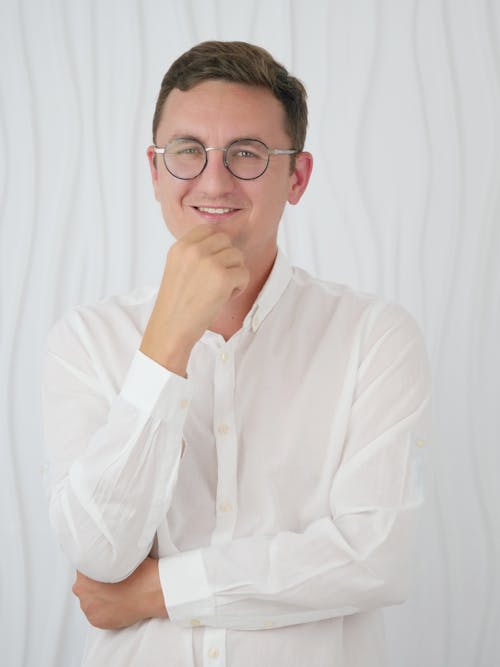 A Man in a White Long Sleeves Wearing Eyeglasses