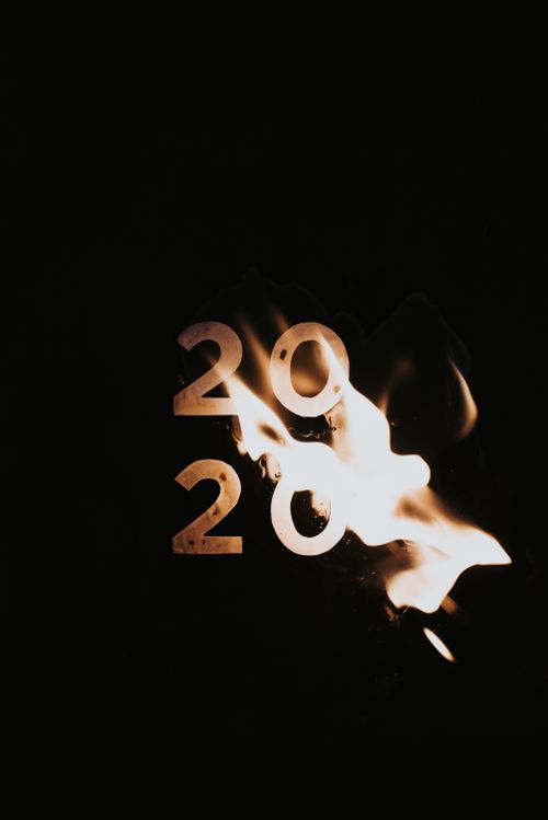 Free Dramatic conceptual art depicting the year 2020 engulfed in flames, symbolizing transformation and renewal. Stock Photo