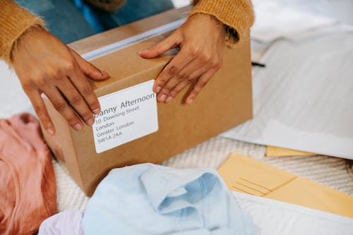 Woman preparing box with parcel for sending