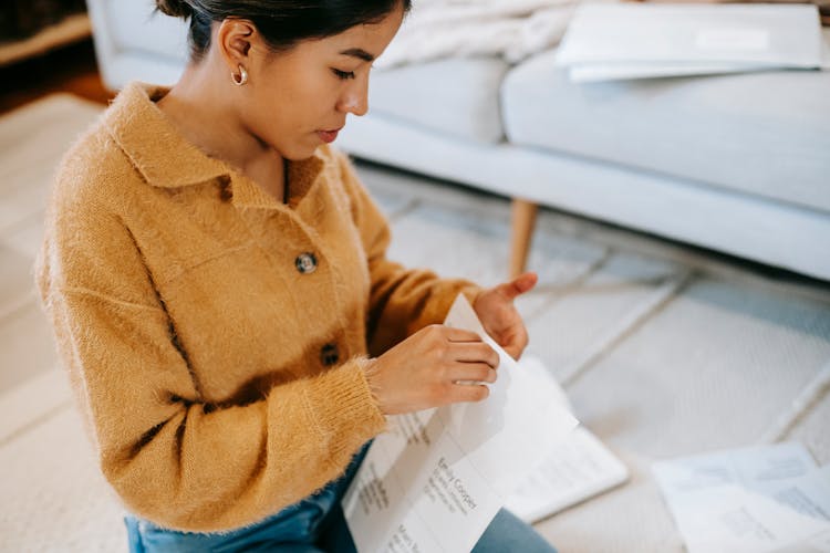 Crop Woman With Paper At Home