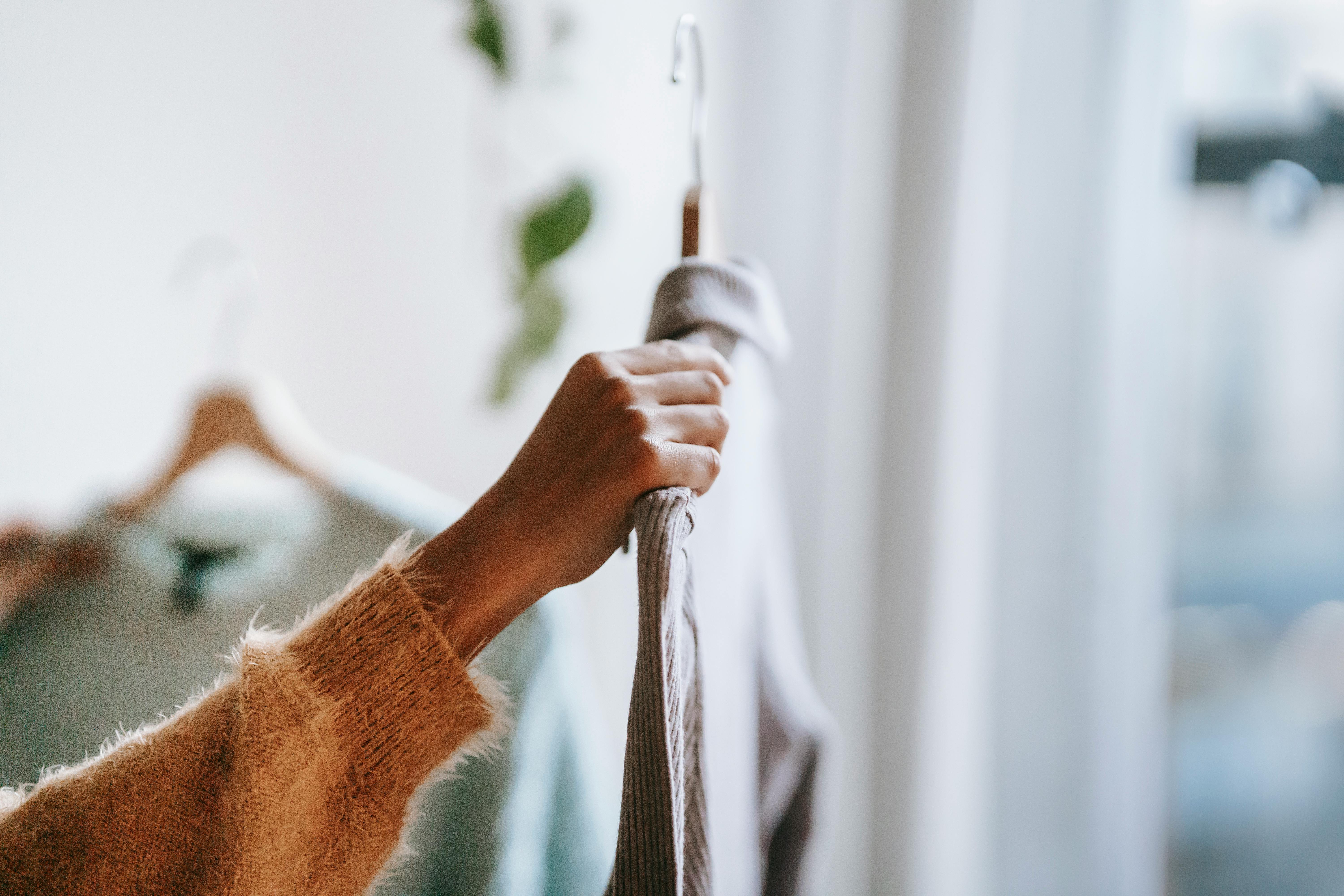 crop woman choosing apparel at home