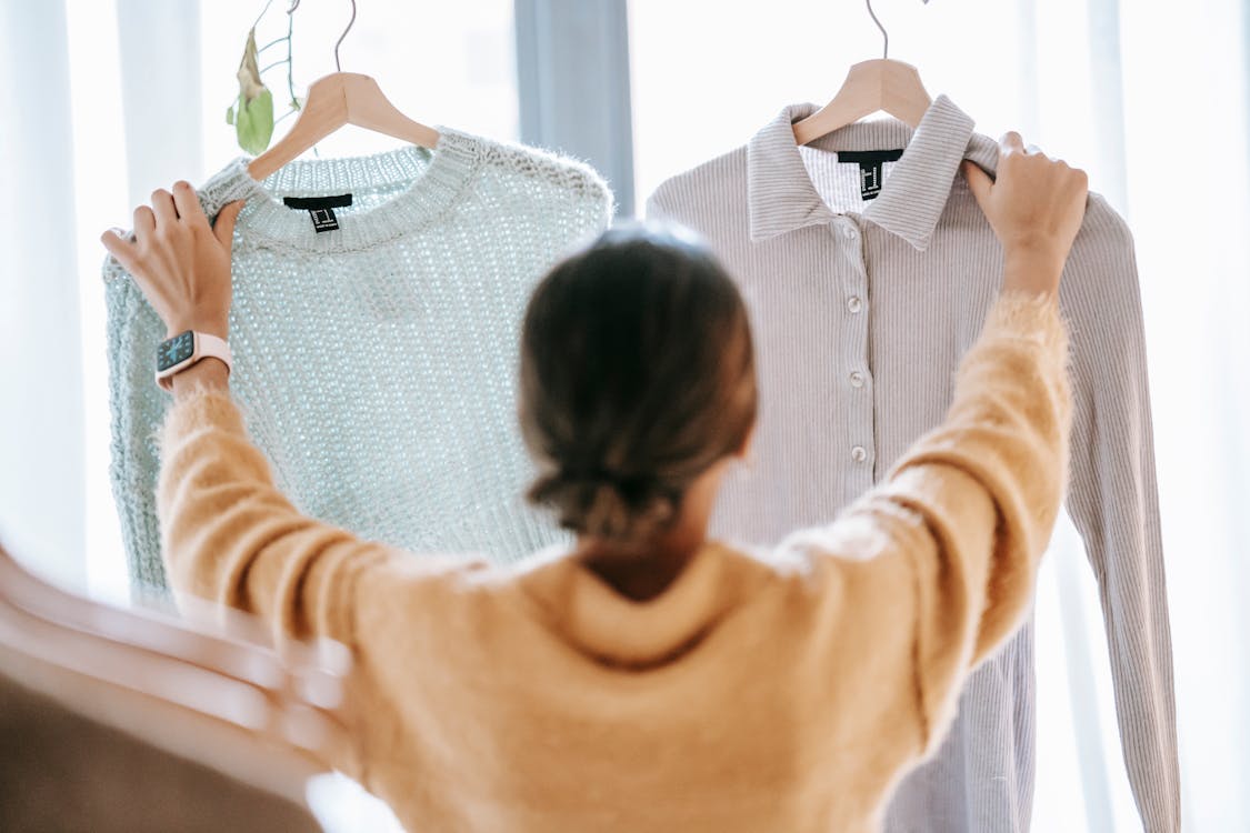 Free Unrecognizable woman demonstrating clothes in store Stock Photo