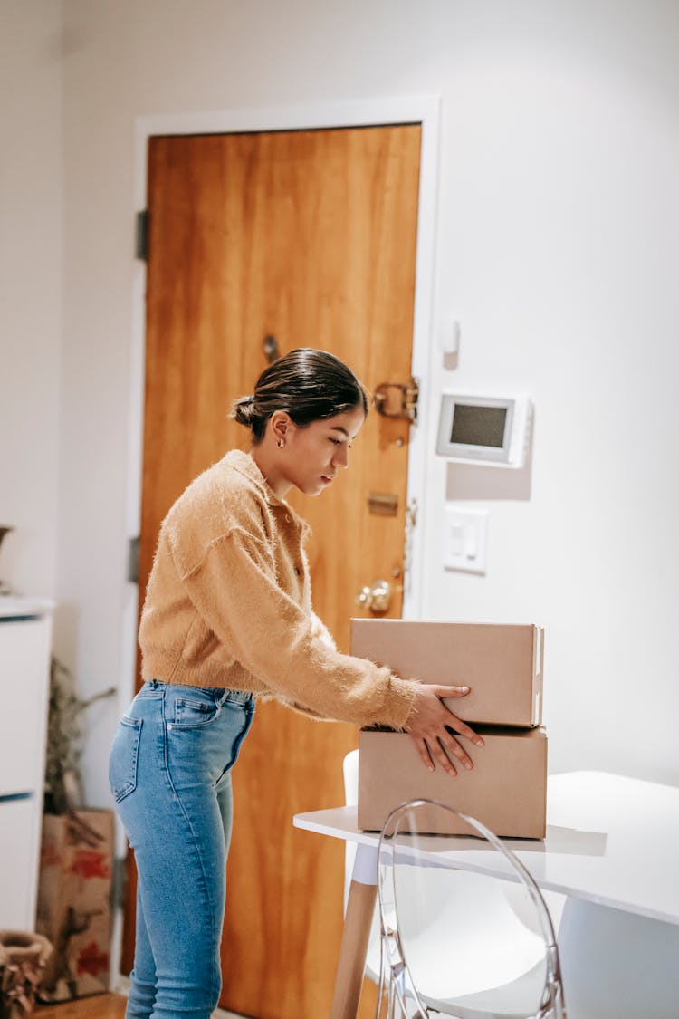 Young Ethnic Woman Packing Carton Boxes