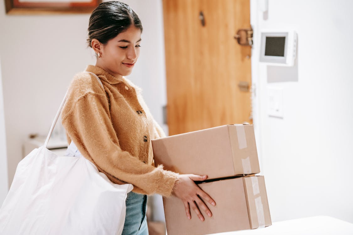 Free Smiling woman with shopping bag and packed goods Stock Photo