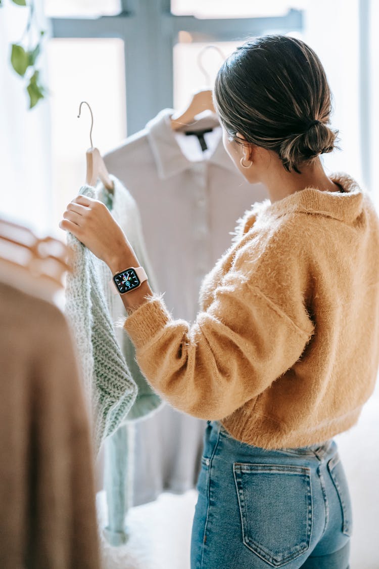 Anonymous Woman Choosing Outfit In Store