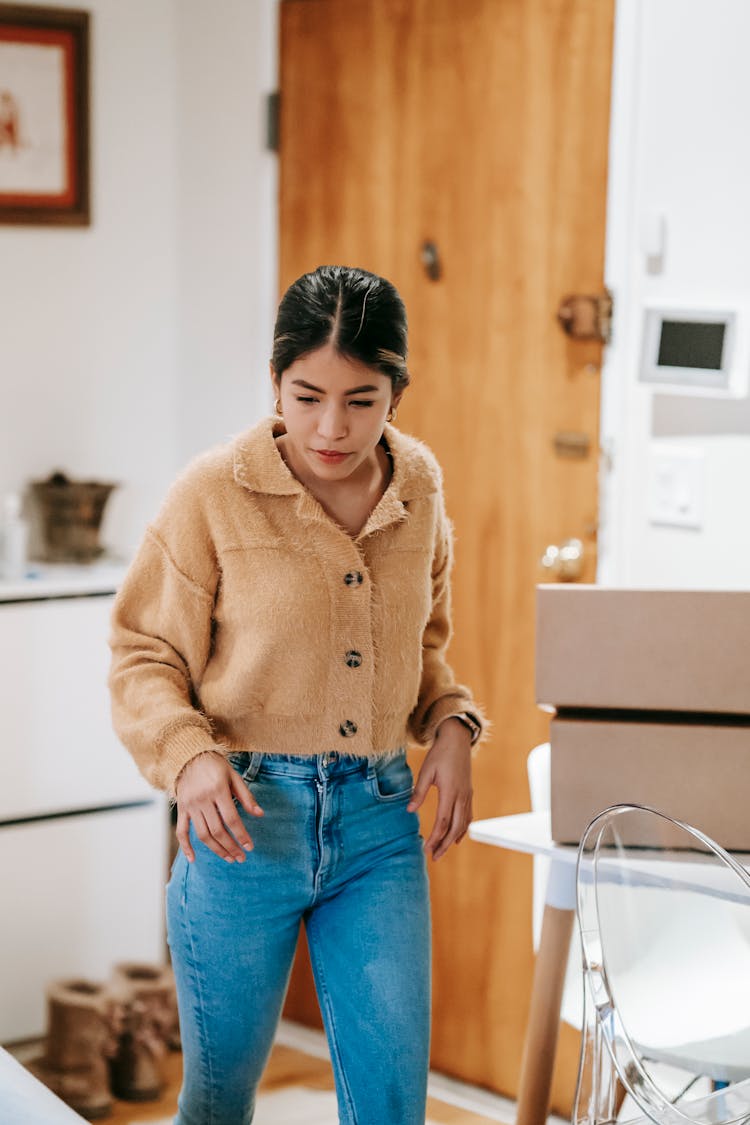 Ethnic Woman Packing Boxes At Home