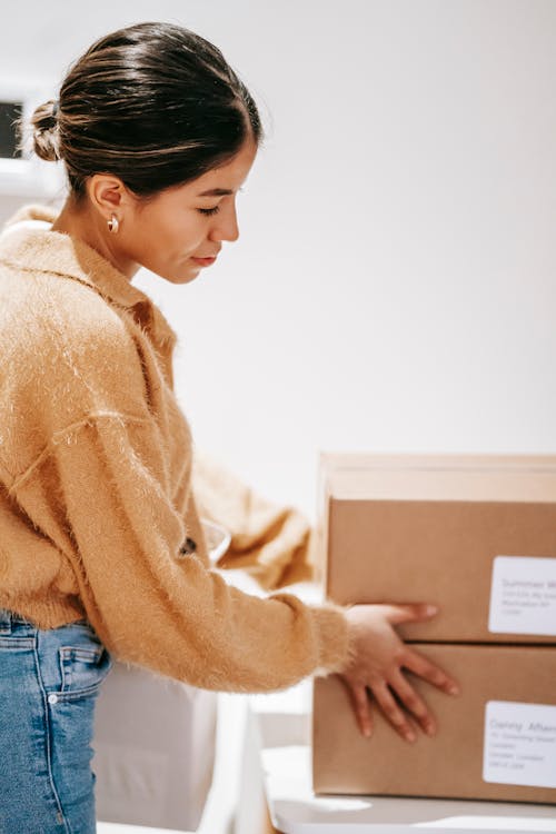 Young woman with delivered carton boxes