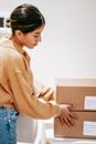 Young woman with delivered carton boxes