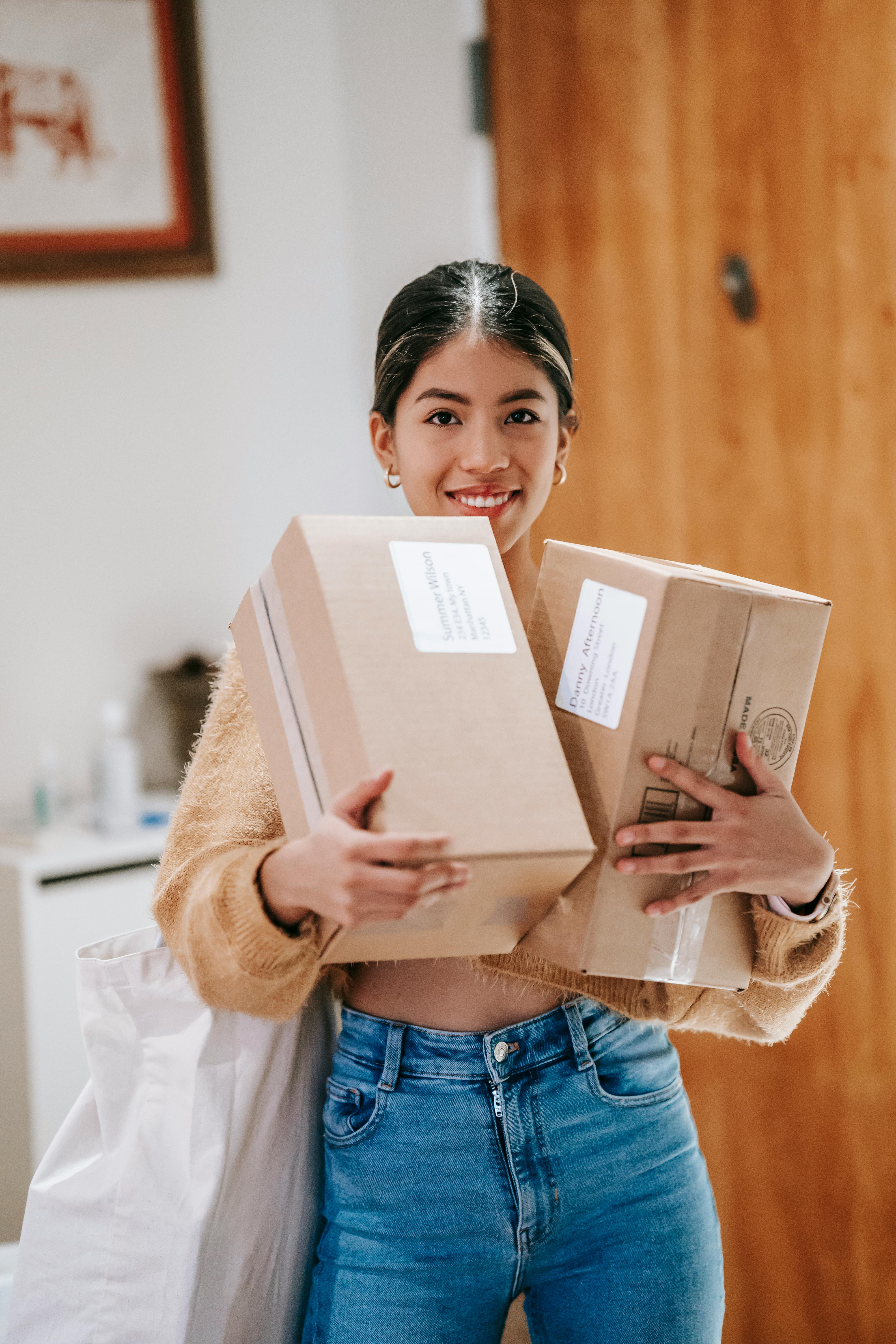 ethnic female with packages in house