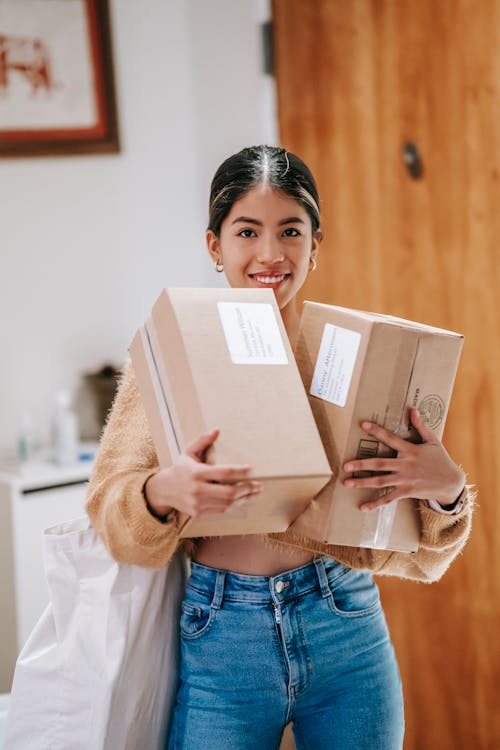 Ethnic female with packages in house