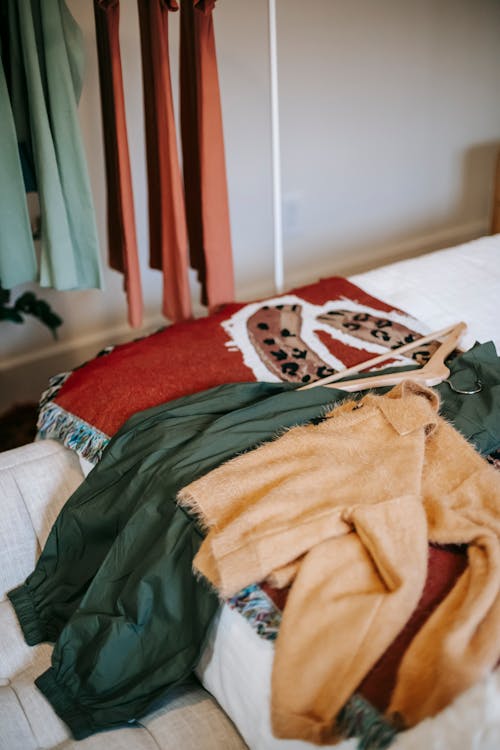 Free Clothes on bed near wardrobe at home Stock Photo