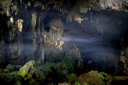 Photo of a Man Alone in a Cave