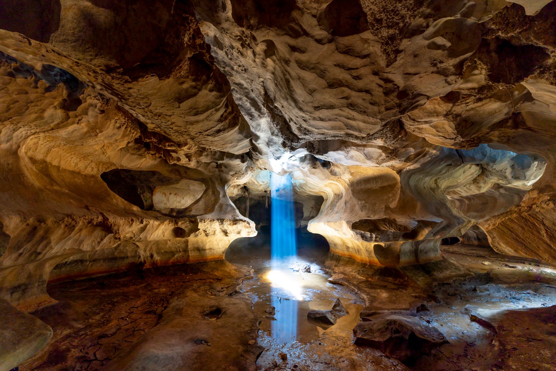 Spectacular view of an underground cave in Vietnam with sunrays illuminating its stunning formations.