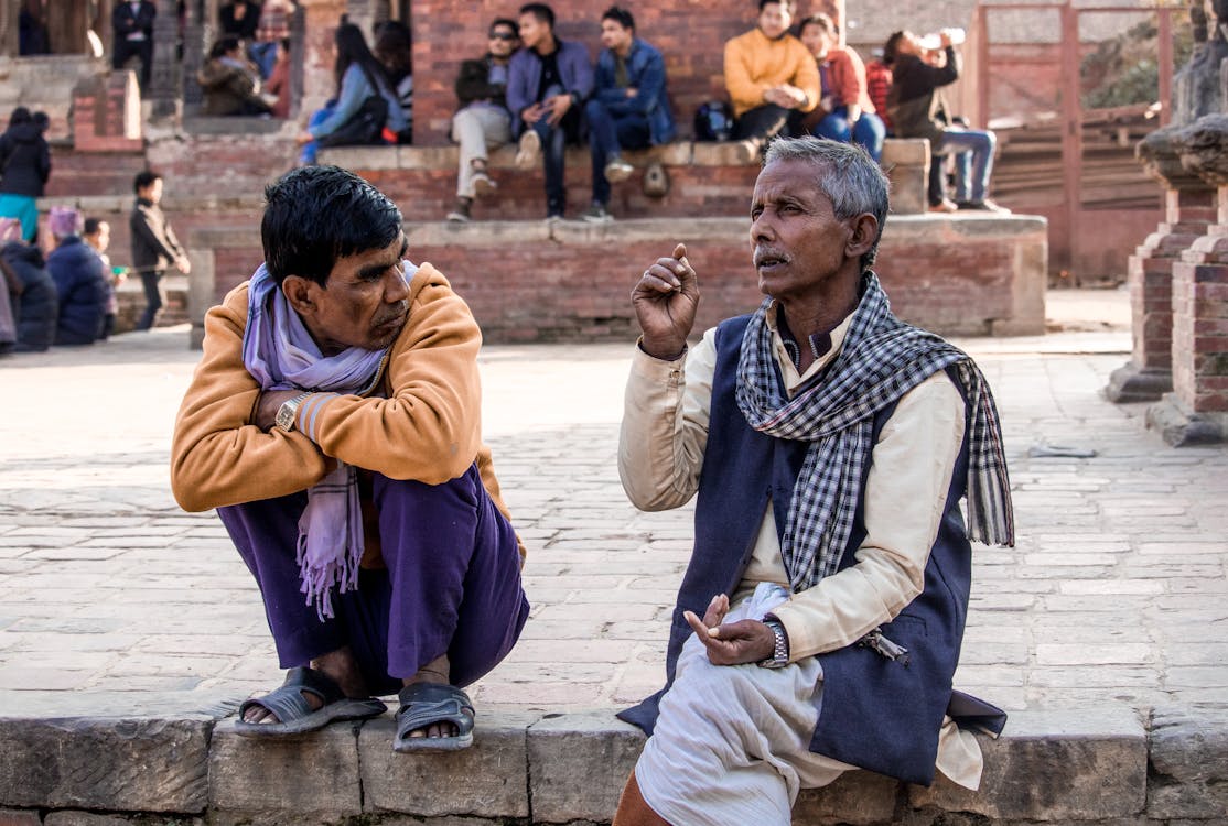 Men Sitting and Talking on City Street