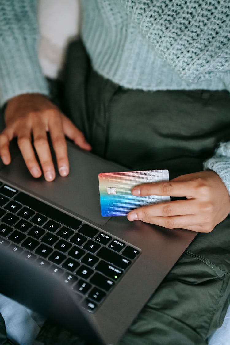 Crop Ethnic Buyer With Plastic Card Shopping Online On Laptop