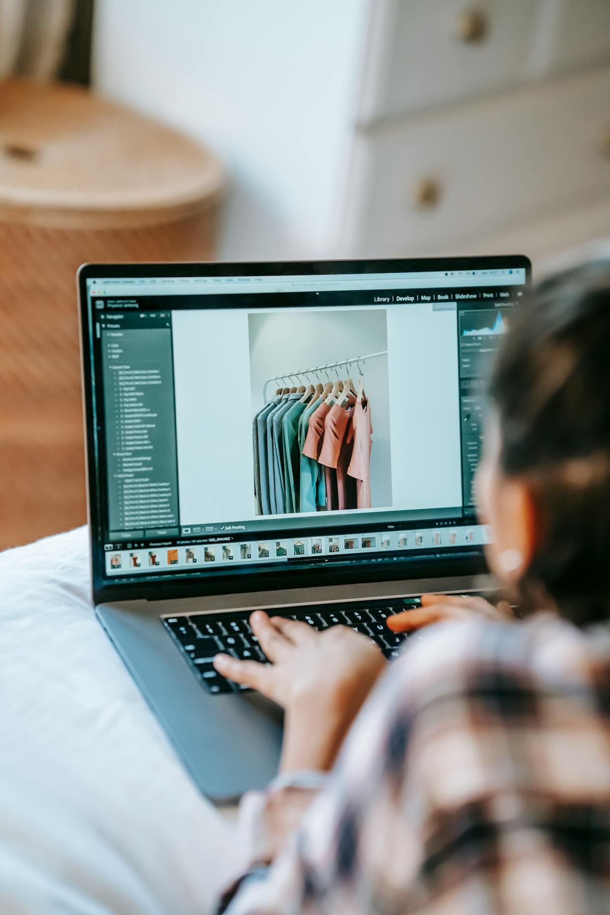 Person checking shopping list on phone while budgeting at a desk