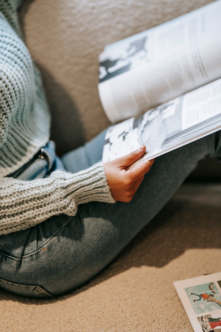 Crop Lady Reading Book On Couch