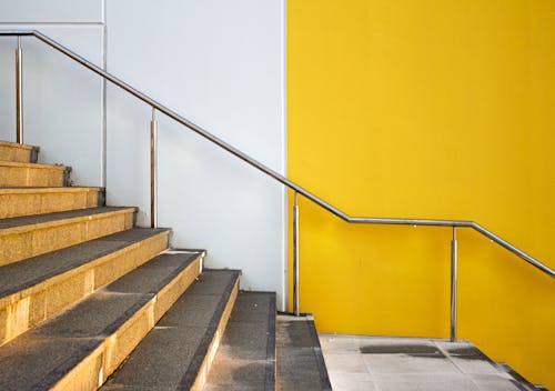 A Staircase Beside a White and Yellow Wall