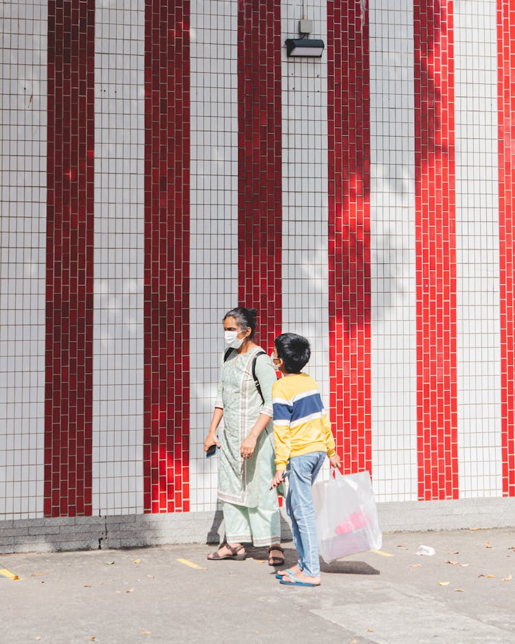 Mother And A Son Wearing Masks On A Street