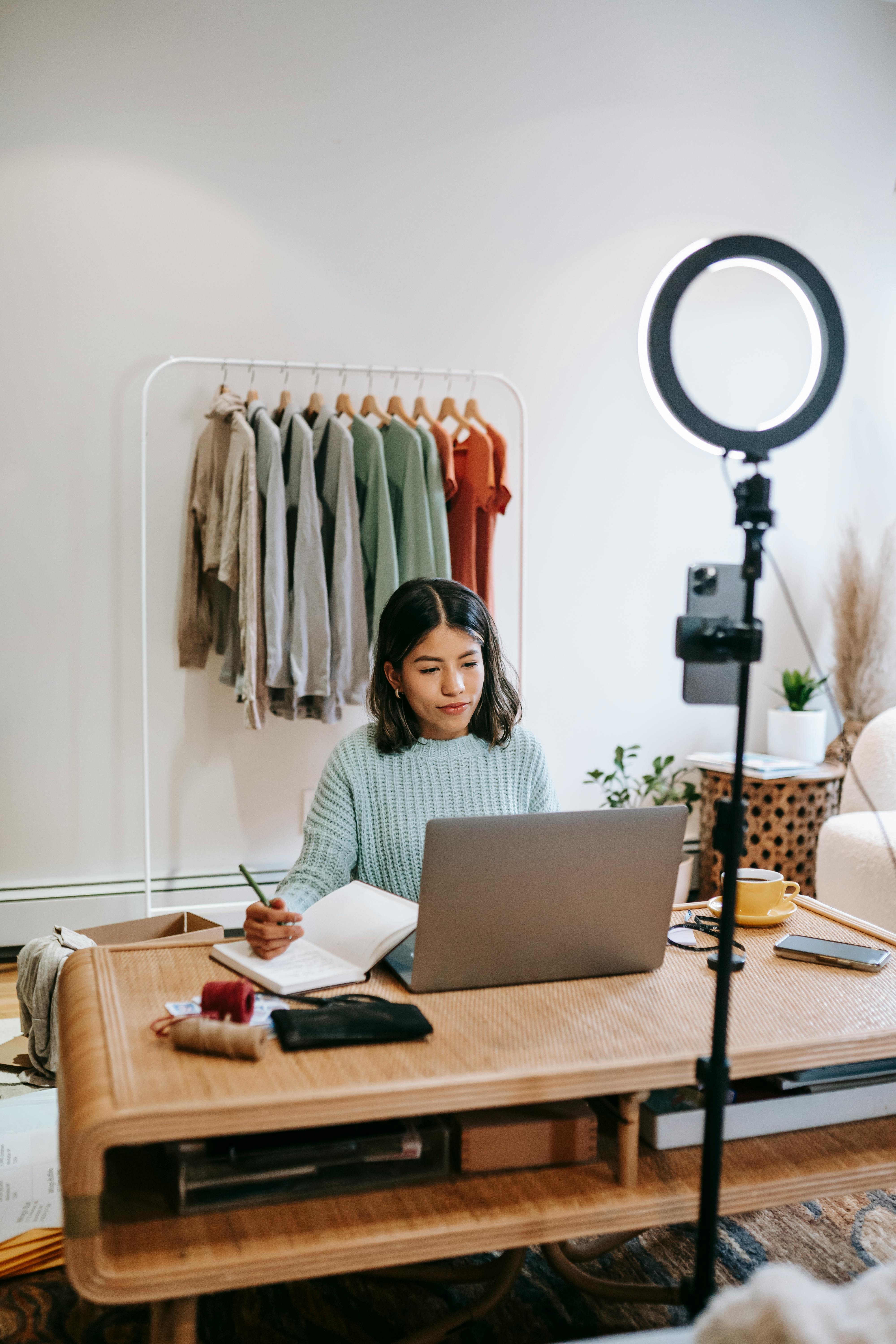 serious female blogger working on computer at table