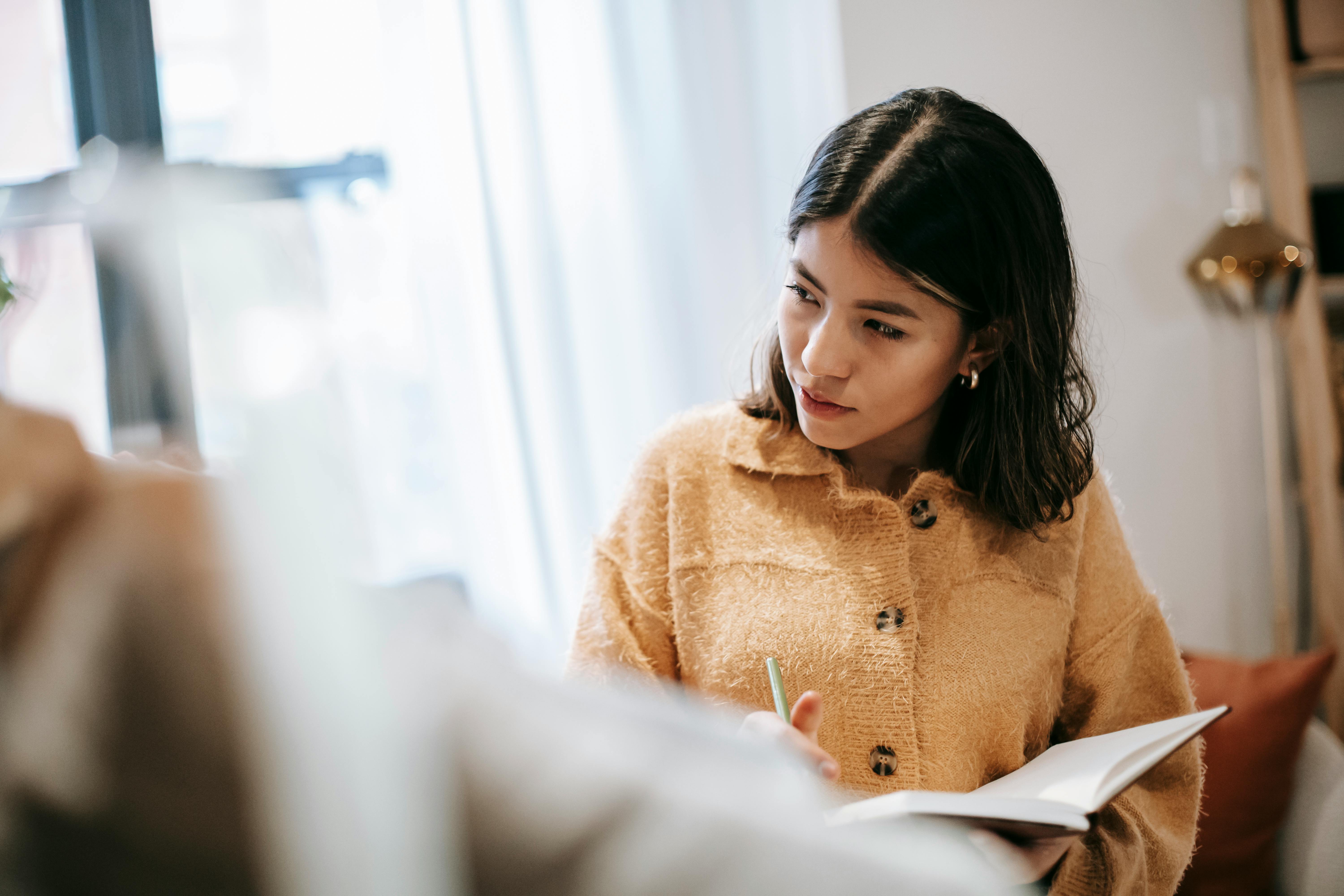 ethnic employee with diary in light house