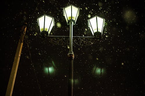 Low Angle Shot of Street Light on Snowy Night