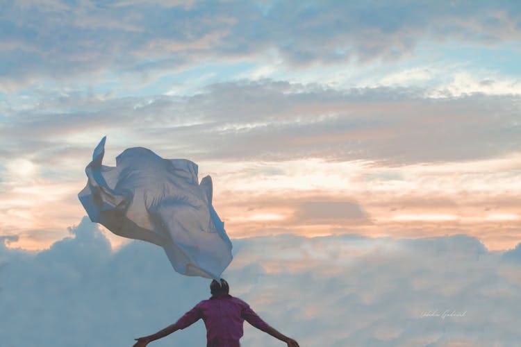 Piece Of Cloth Flowing In The Sky Above Man