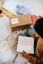 Crop unrecognizable woman preparing carton box for sending