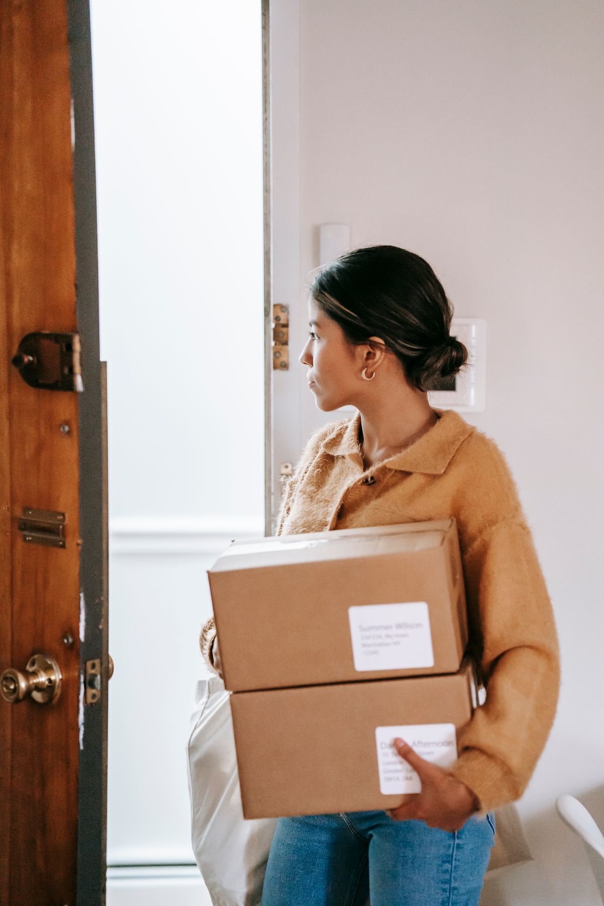 Customer carrying packaged online purchases at home