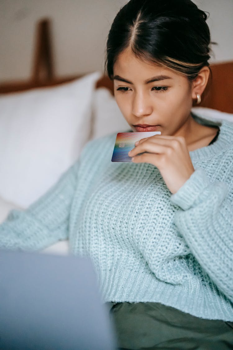 Crop Focused Asian Woman Using Laptop And Making Online Transfer