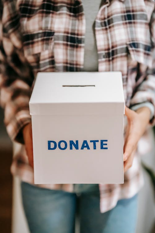 Free Crop anonymous person showing donation box Stock Photo