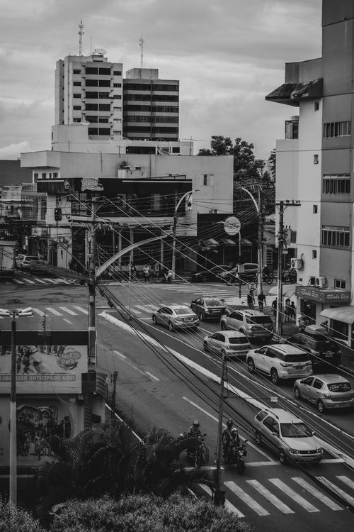 Free A busy city intersection captured in grayscale, highlighting urban life and architecture. Stock Photo