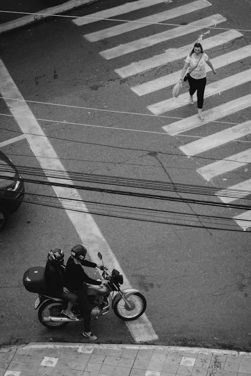 Free Grayscale Photo of a Pedestrian Crossing the Street Stock Photo