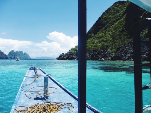 Free Experience the serene beauty of a tropical island from a boat with turquoise waters. Stock Photo