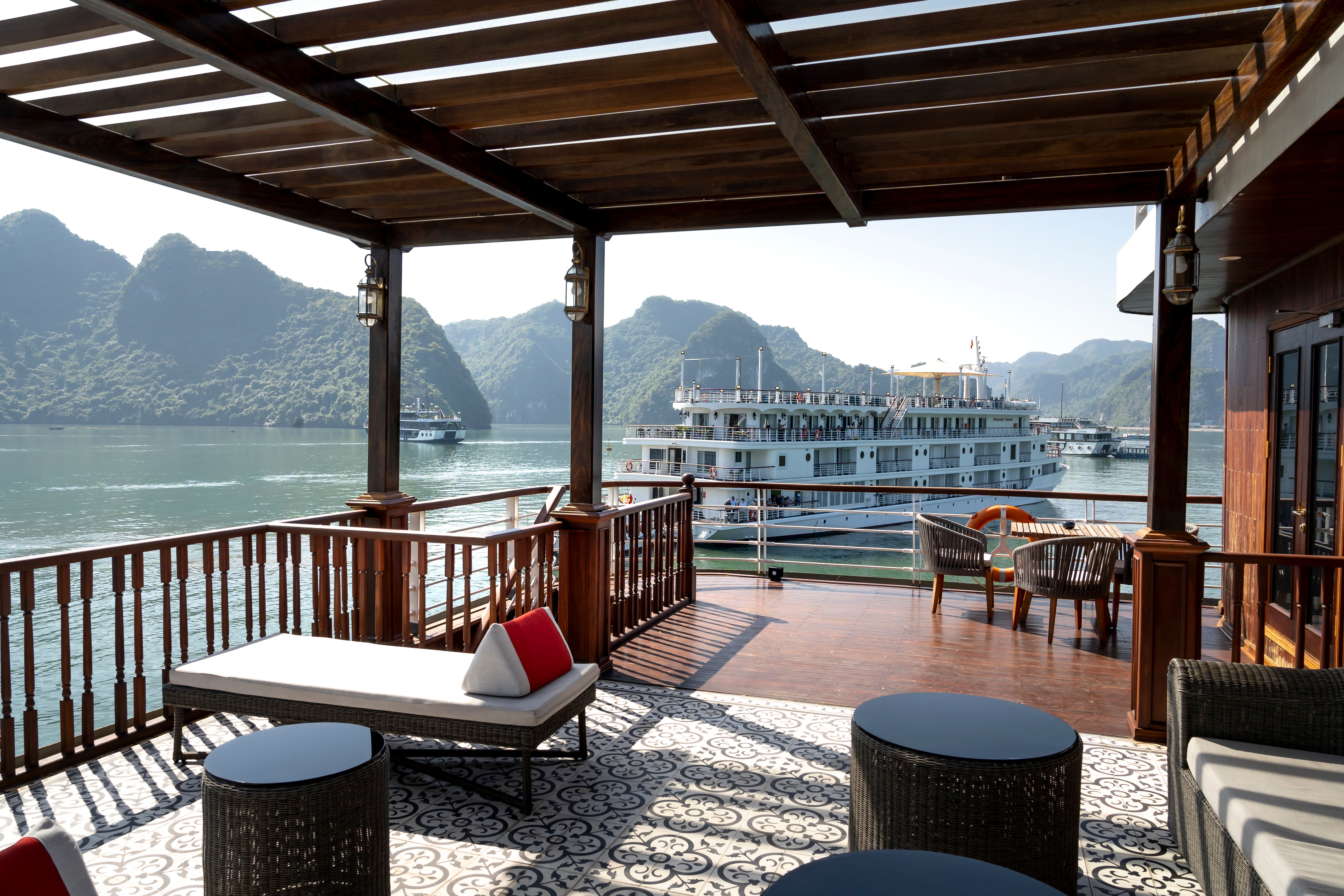 Elegant yacht deck with stunning bay view, featuring comfortable seating and scenic surroundings.