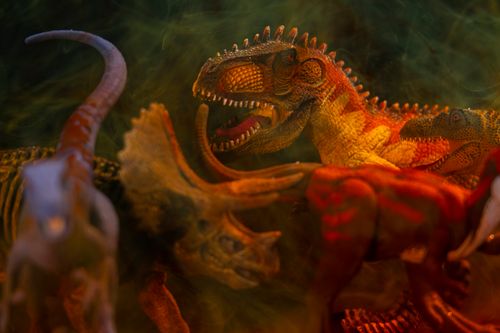 Free Close-up of dinosaur toys with dramatic lighting and smoky effects. Stock Photo