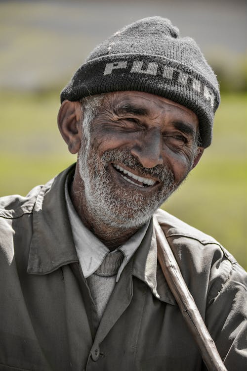 A Smiling Elderly Man Wearing a Knit Cap